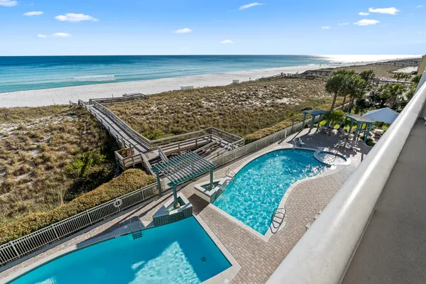 a view of a roof deck with wooden floor and ocean view