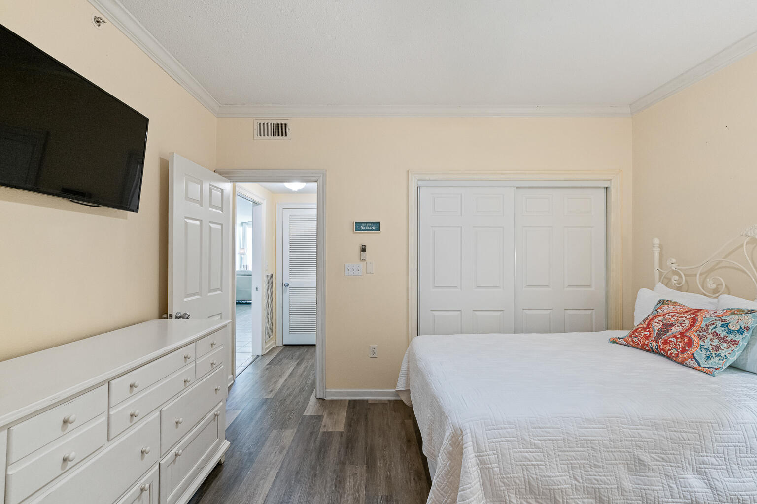 8499 Gulf Boulevard, Unit 303 Navarre, FL 32566 - Photo 23 of 52 a bedroom with a bed and a flat screen tv