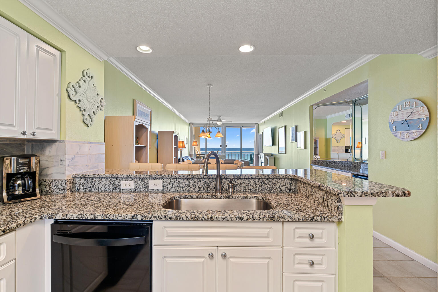 8499 Gulf Boulevard, Unit 303 Navarre, FL 32566 - Photo 32 of 52 a kitchen with stainless steel appliances granite countertop a sink and cabinets