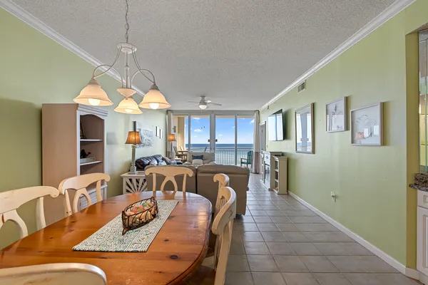 a view of a a dining room with furniture window and wooden floor