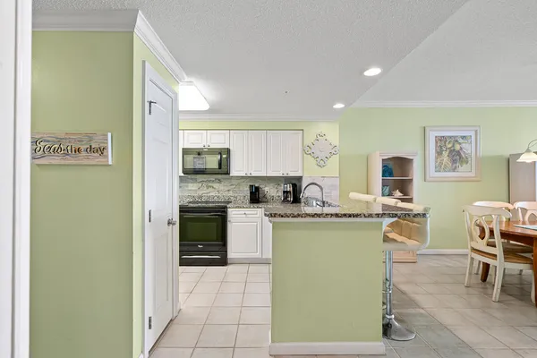 a kitchen with stainless steel appliances granite countertop a sink and cabinets
