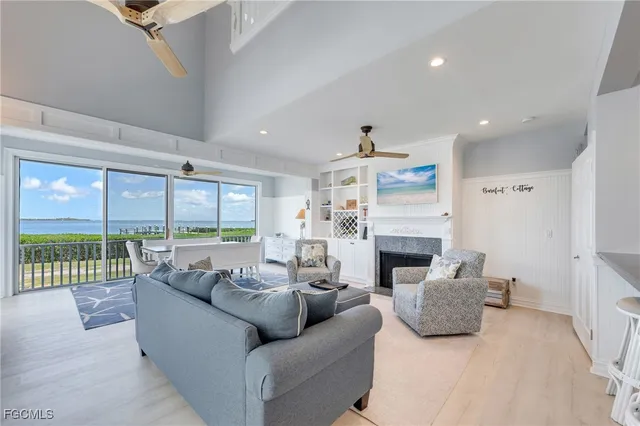 a living room with furniture fireplace and a floor to ceiling window