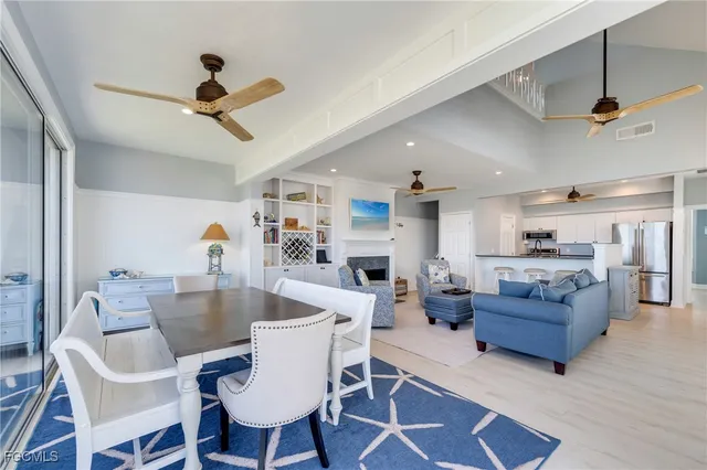 a view of a dining room with furniture a rug and wooden floor