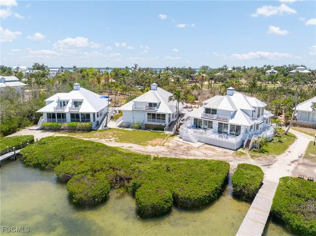 a aerial view of a house with a garden and lake view