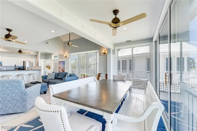 a large dining space with furniture a chandelier and wooden floor