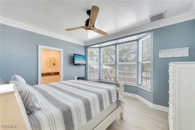 a bedroom with a large bed and a large window