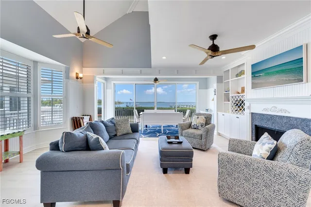 a living room with furniture ceiling fan and a fireplace