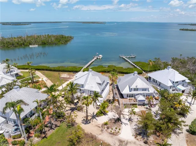 an aerial view of a house with a lake