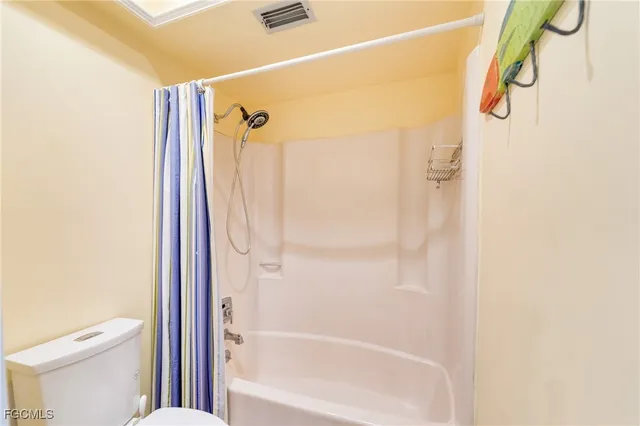 a bathroom with a shower and a toilet