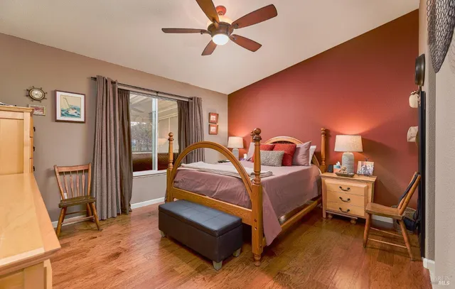 a spacious bedroom with a bed and a chandelier