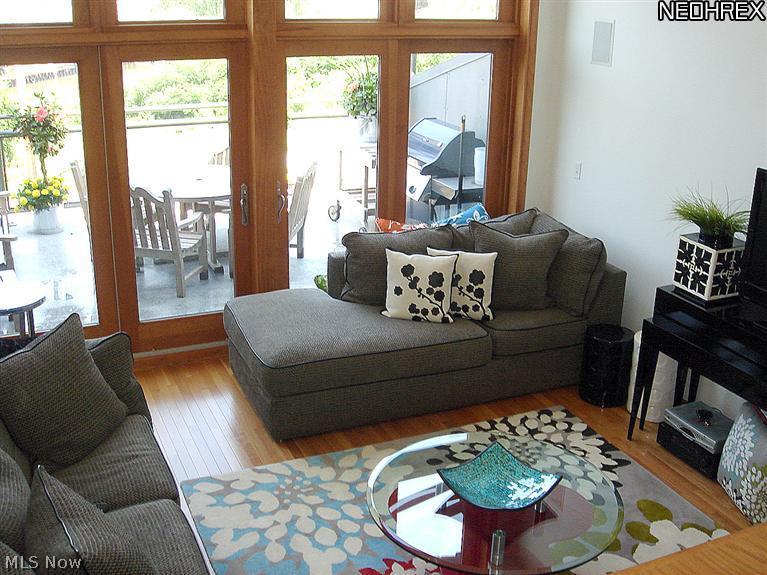 1931 Columbus Road Cleveland, OH 44113 - Photo 9 of 20 1.5 story "sunken" living room with fireplace and dual stairs. Floor to ceiling windows with double doors to main-level deck.