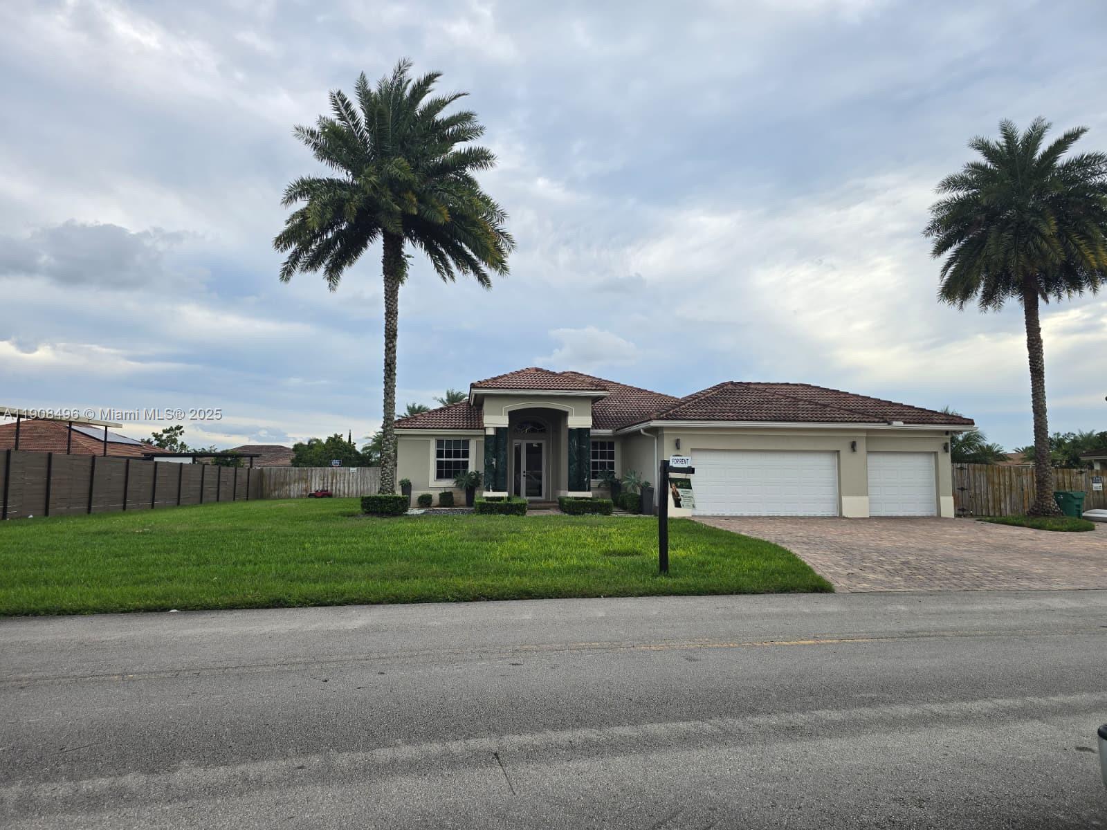 a front view of a house with a garden and yard