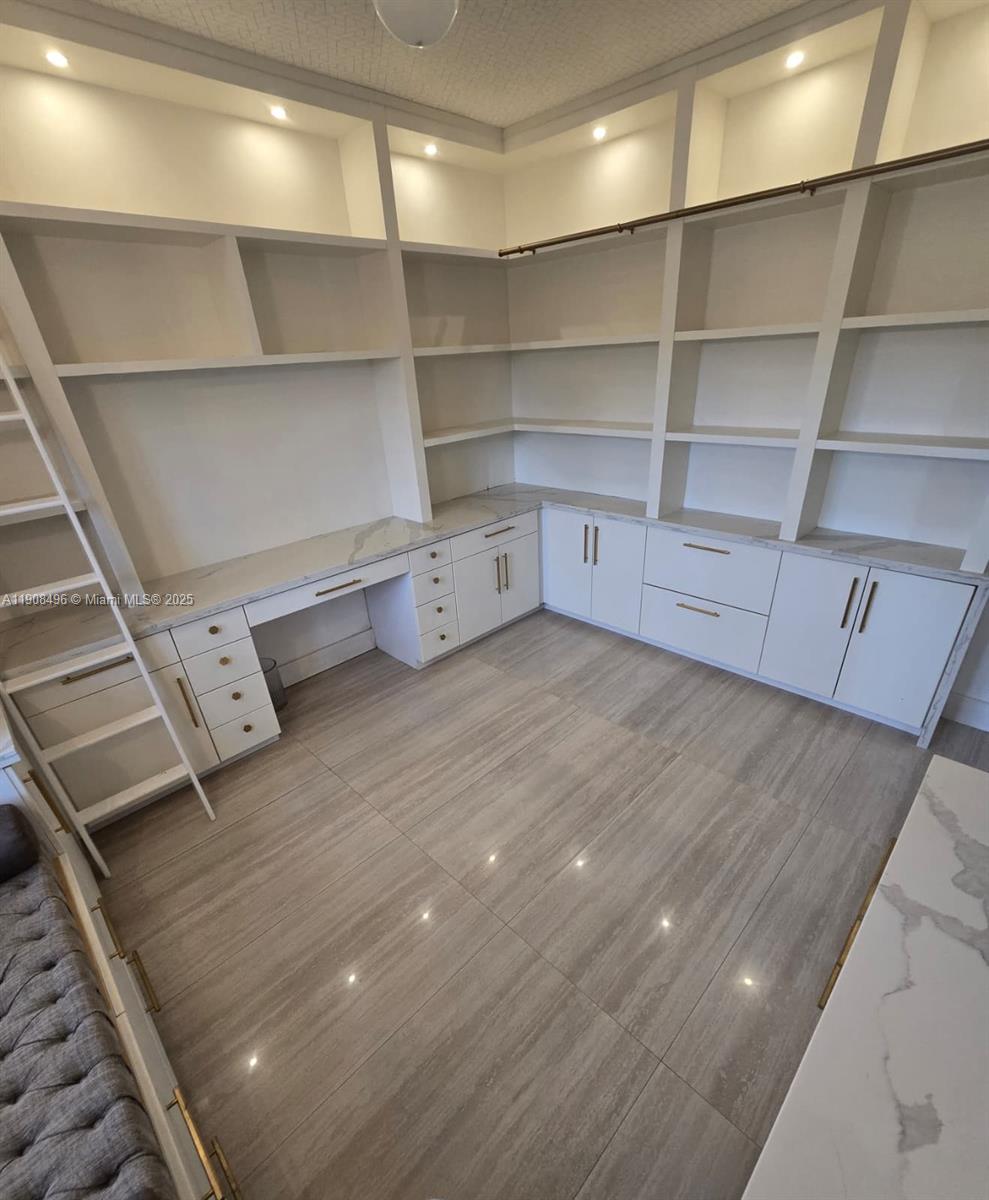 12944 Southwest 222nd Street Miami, FL 33170 - Photo 14 of 44 a view of walk in closet with empty racks