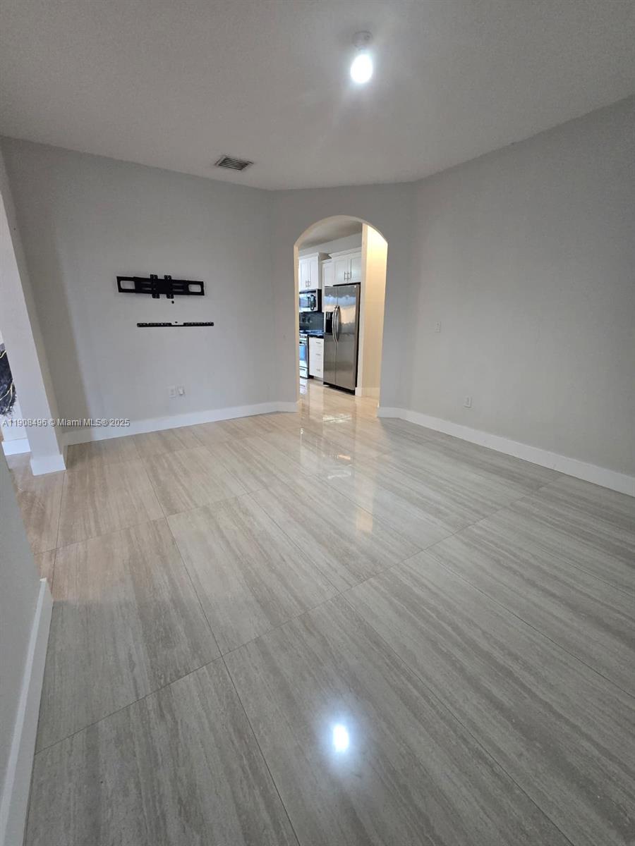 12944 Southwest 222nd Street Miami, FL 33170 - Photo 16 of 44 wooden floor in an empty room with a window