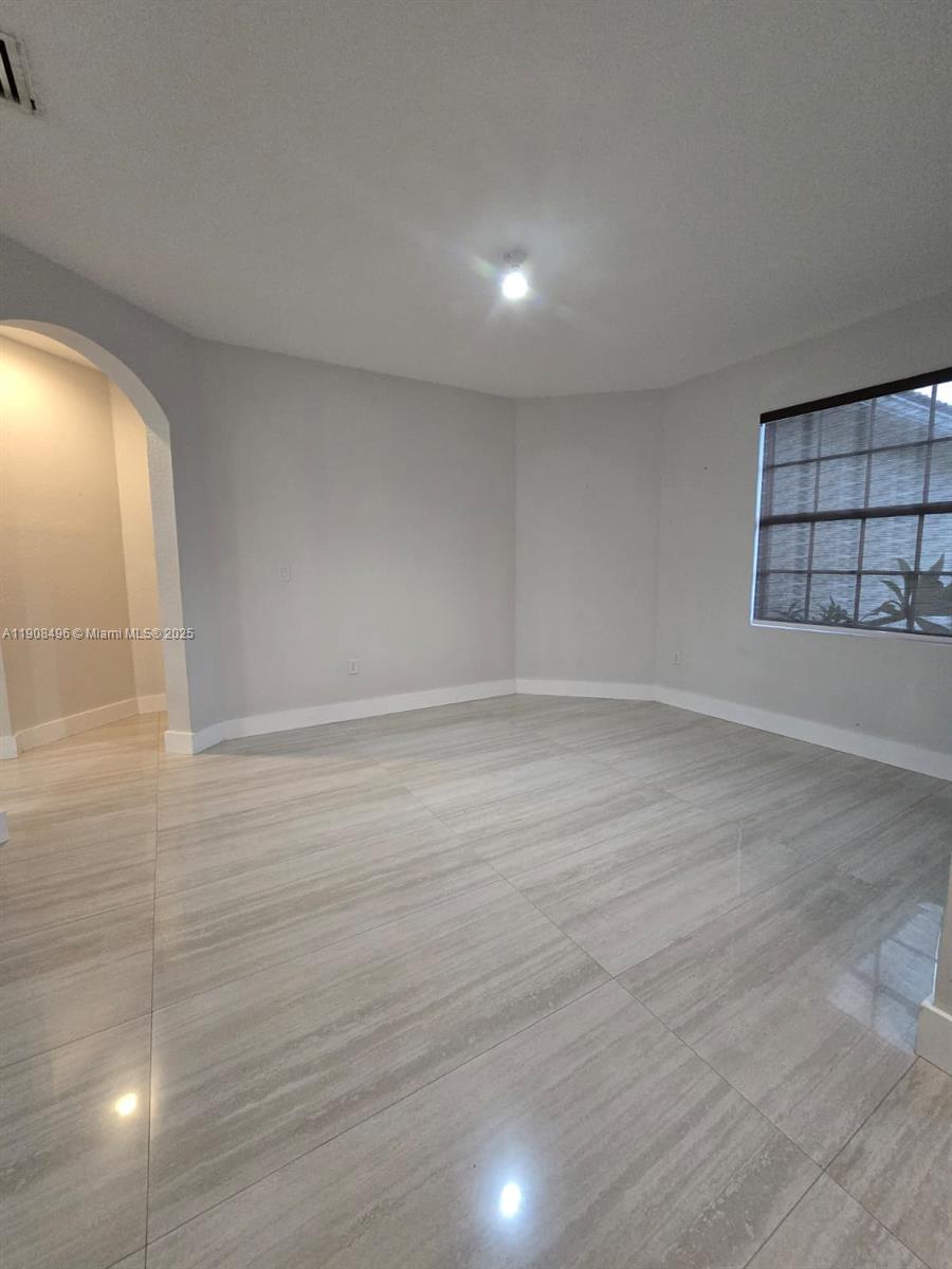 12944 Southwest 222nd Street Miami, FL 33170 - Photo 17 of 44 wooden floor in an empty room with a window