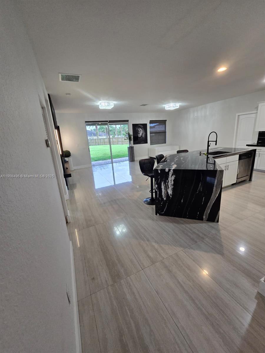 12944 Southwest 222nd Street Miami, FL 33170 - Photo 18 of 44 a living room with furniture and a wooden floor