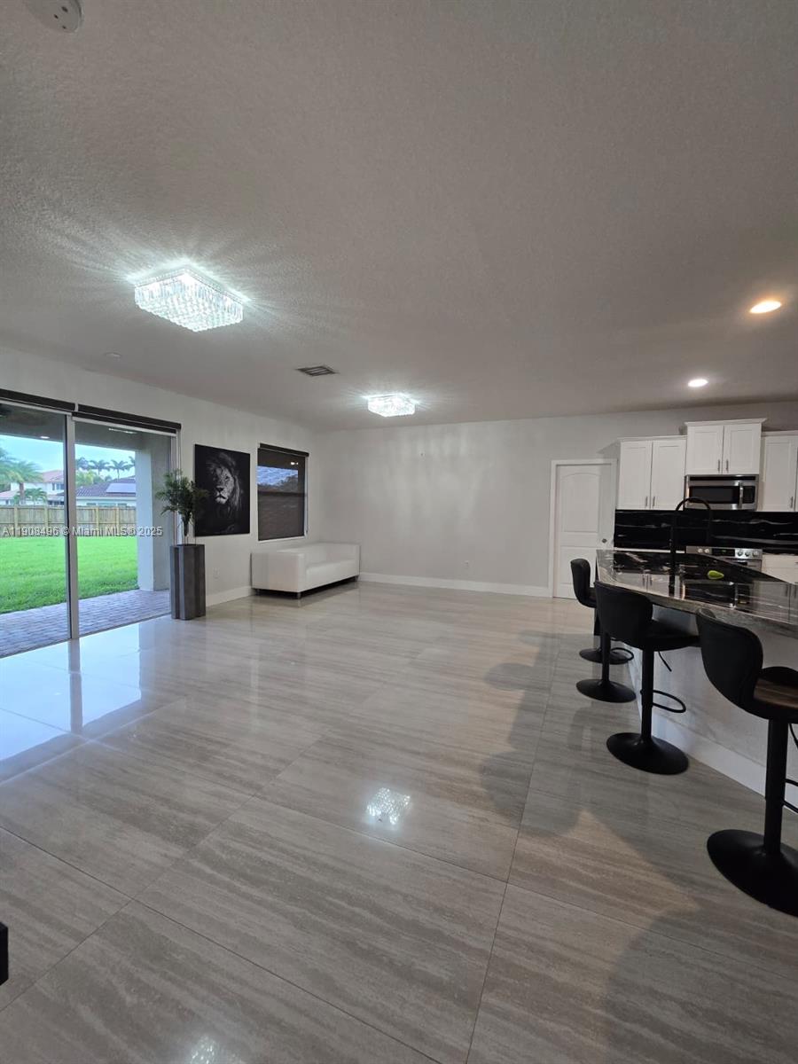 12944 Southwest 222nd Street Miami, FL 33170 - Photo 20 of 44 a living room with furniture and a wooden floor