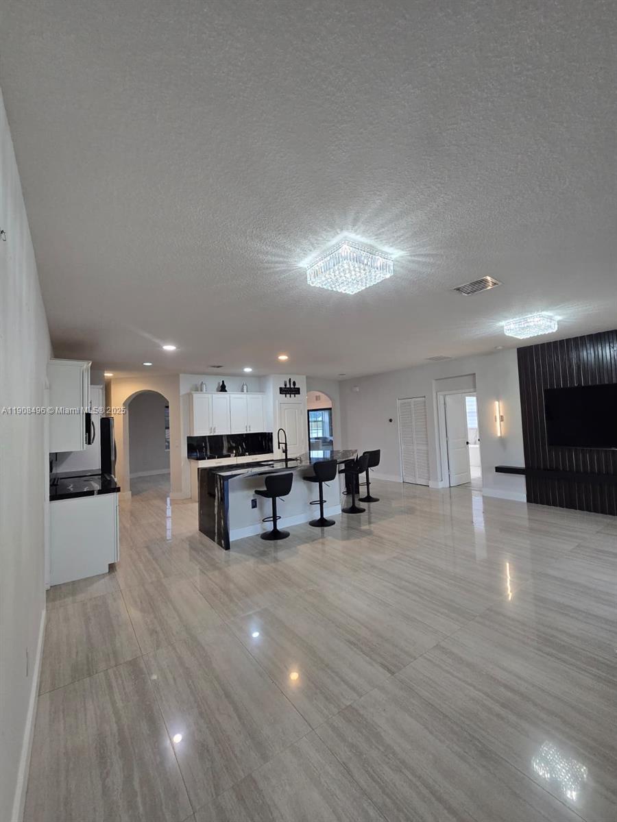 12944 Southwest 222nd Street Miami, FL 33170 - Photo 21 of 44 a living room with furniture and kitchen view