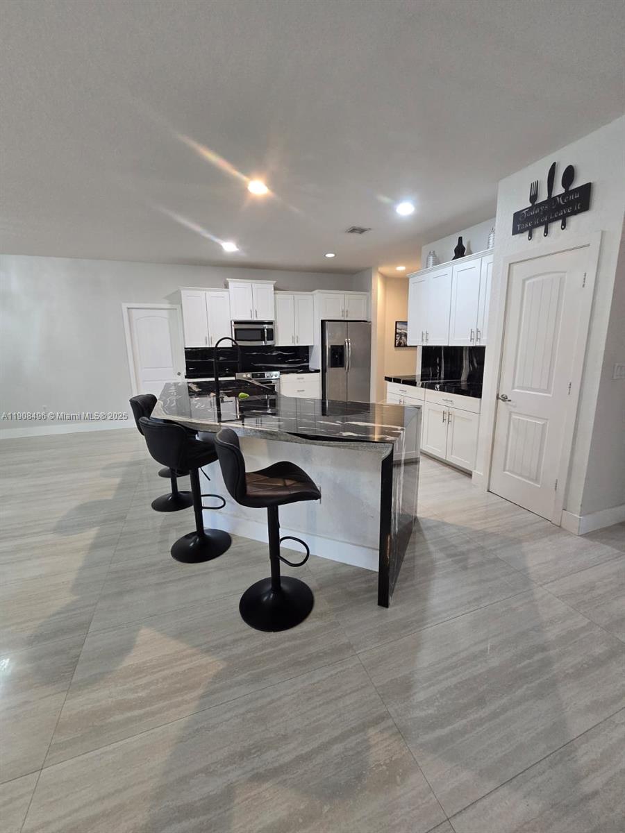 12944 Southwest 222nd Street Miami, FL 33170 - Photo 24 of 44 a living room with furniture and a chandelier