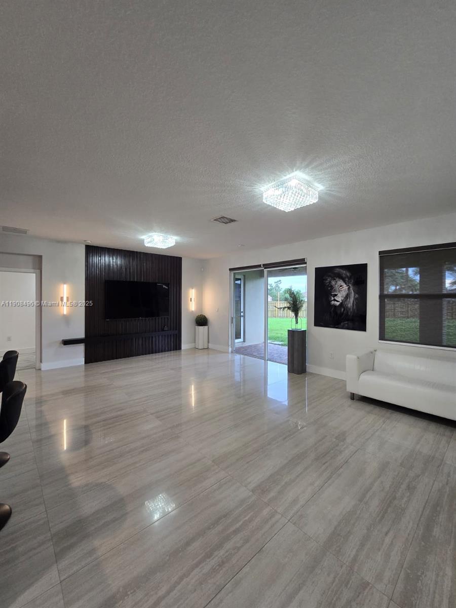 12944 Southwest 222nd Street Miami, FL 33170 - Photo 25 of 44 a view of a livingroom with furniture and a fireplace
