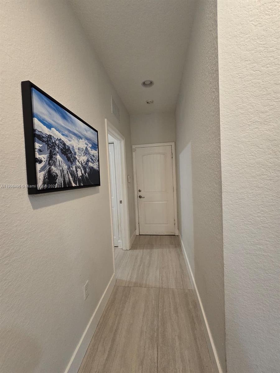 12944 Southwest 222nd Street Miami, FL 33170 - Photo 27 of 44 a view of a hallway with wooden floor