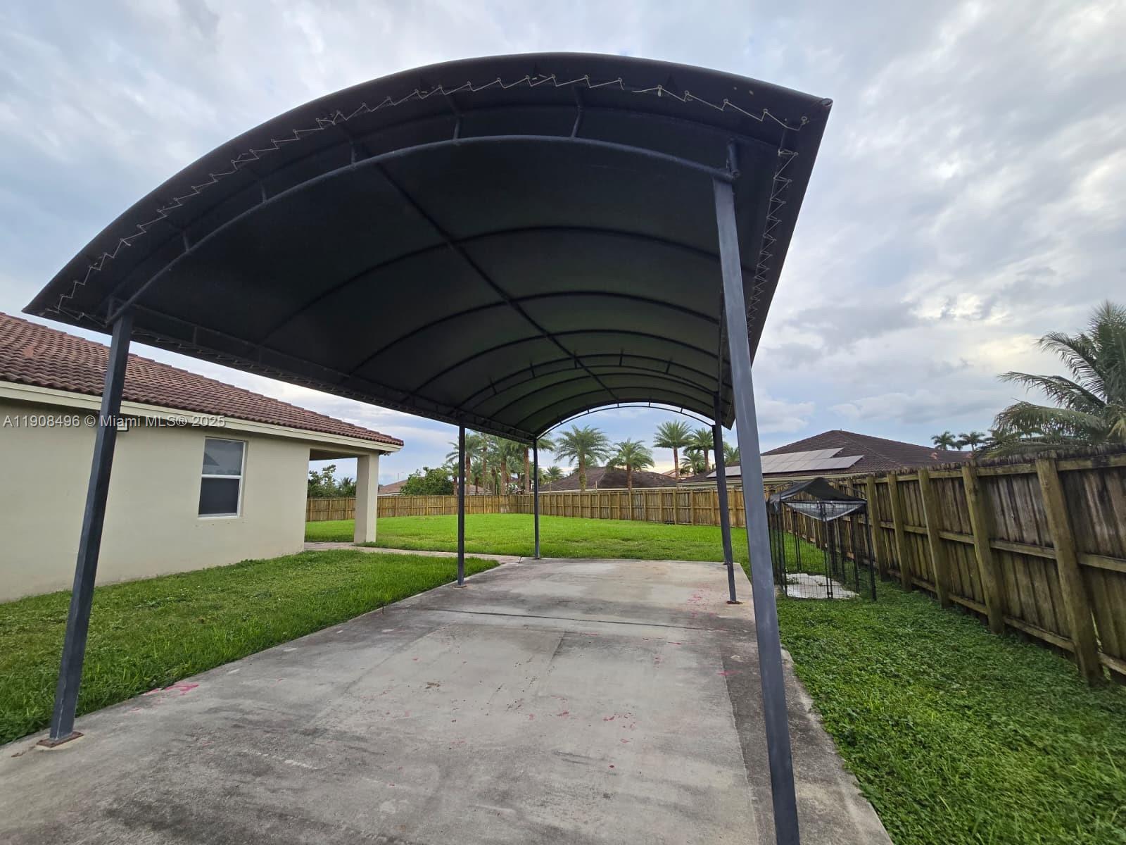 12944 Southwest 222nd Street Miami, FL 33170 - Photo 38 of 44 a view of a house with backyard and porch