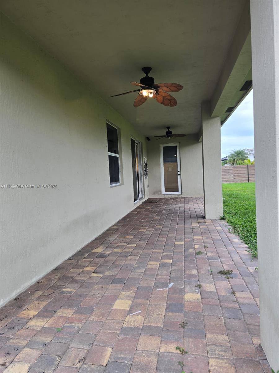 12944 Southwest 222nd Street Miami, FL 33170 - Photo 40 of 44 a view of a big room with windows and chandelier fan