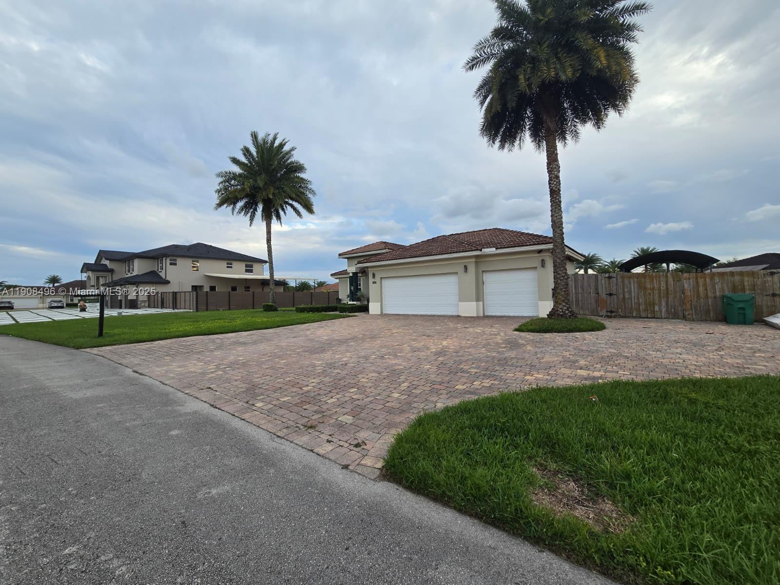 12944 Southwest 222nd Street Miami, FL 33170 - Photo 4 of 44 a front view of house with yard and entertaining space