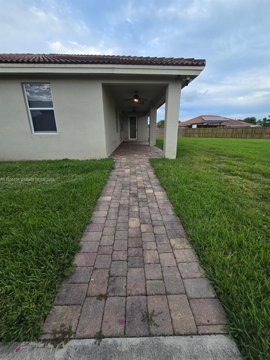 12944 Southwest 222nd Street Miami, FL 33170 - Photo 42 of 44 a front view of a house with garden