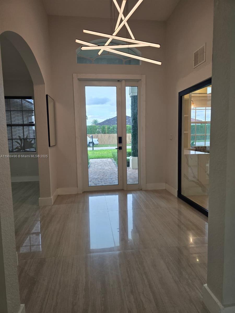 12944 Southwest 222nd Street Miami, FL 33170 - Photo 7 of 44 wooden floor in an empty room with a window