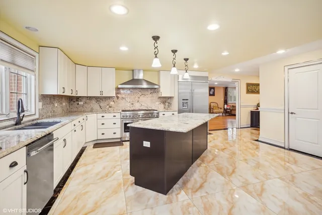 a large kitchen with a table and chairs