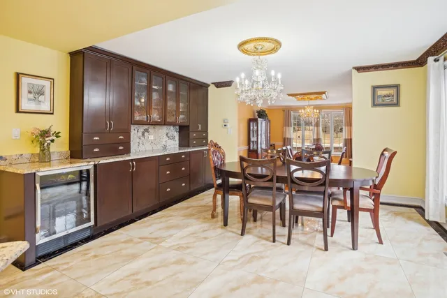a view of a dining room with furniture wooden floor and chandelier