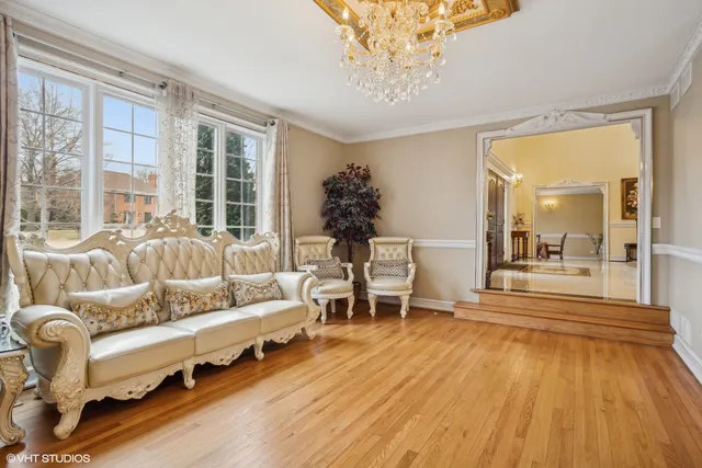 a living room with furniture and a chandelier