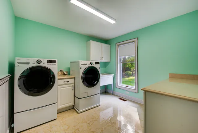 a living room with furniture a flat screen tv and a table