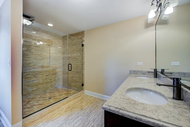 a spacious bathroom with a granite countertop sink mirror and toilet