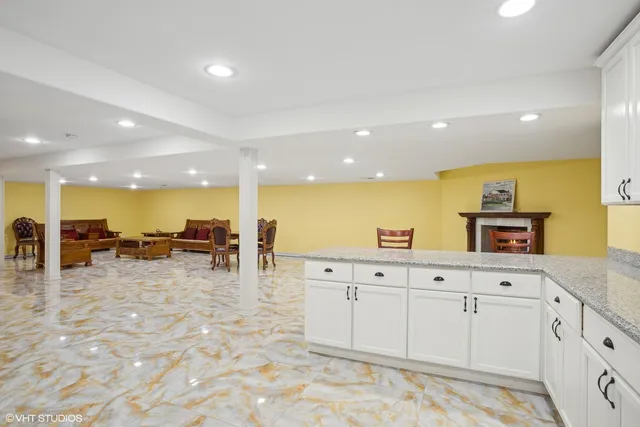 a kitchen with granite countertop a refrigerator sink and cabinets