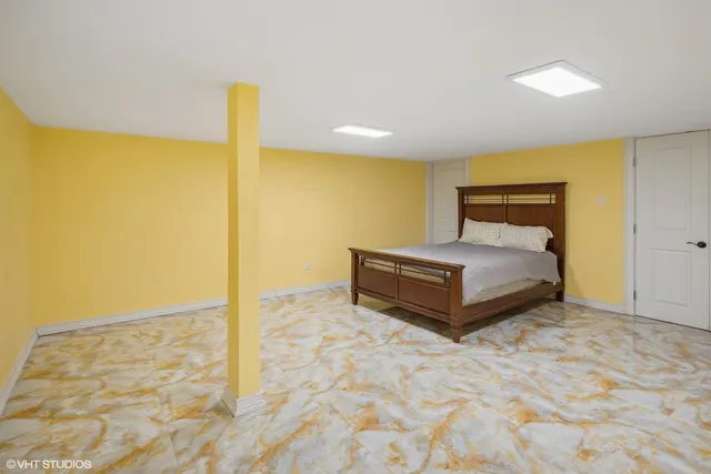 a bathroom with a granite countertop sink a toilet a mirror a bathtub and shower