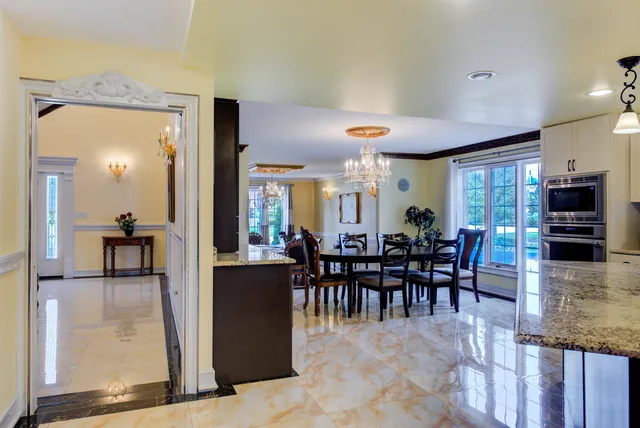 a large kitchen with kitchen island a sink a center island a stove and a center island