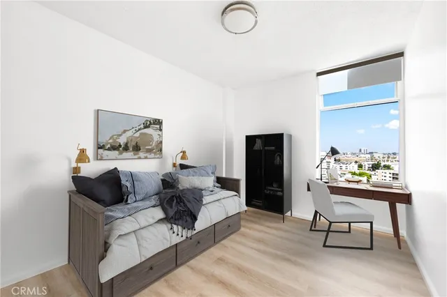 a living room with furniture and a painting on the wall