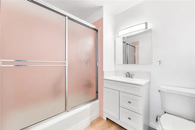 a bathroom with a toilet a sink and a mirror