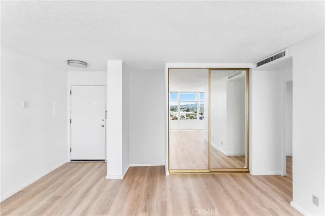 a view of an empty room and wooden floor