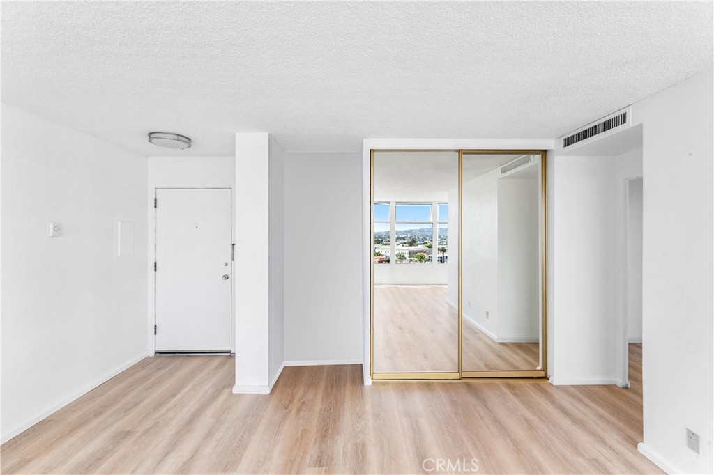 100 Atlantic Avenue, Unit 1005 Long Beach, CA 90802 - Photo 3 of 19 a view of an empty room and wooden floor