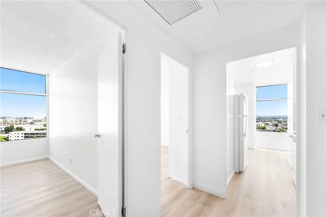 a view of a hallway with closet and a living room
