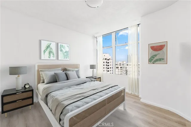 a bedroom with a bed and a painting on the wall