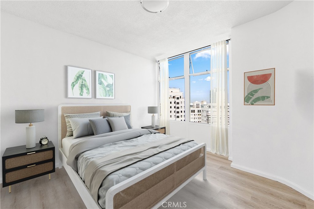 100 Atlantic Avenue, Unit 1005 Long Beach, CA 90802 - Photo 9 of 19 a bedroom with a bed and a painting on the wall