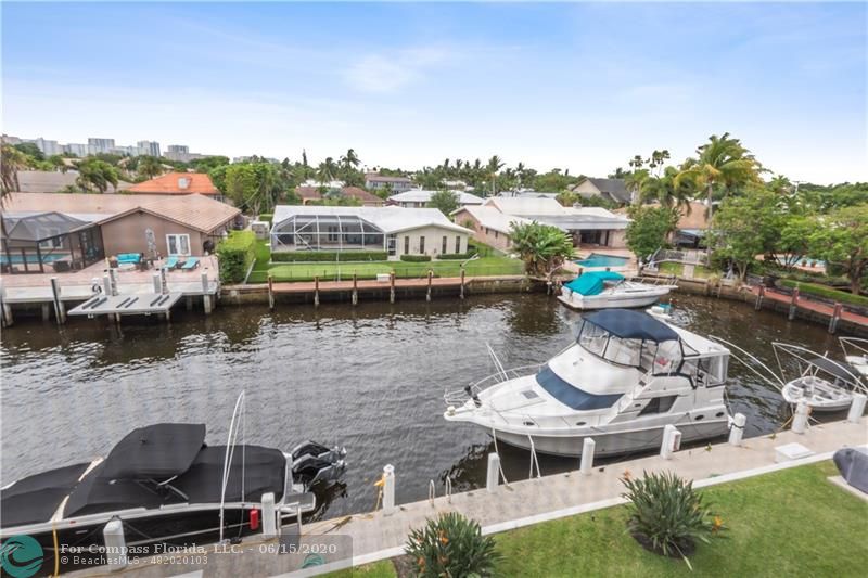 3050 Northeast 47th Court, Unit 301 Fort Lauderdale, FL 33308 - Photo 1 of 19 a view of a lake with a house in the background