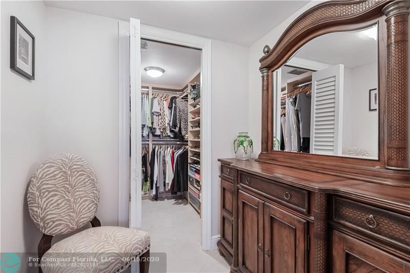 3050 Northeast 47th Court, Unit 301 Fort Lauderdale, FL 33308 - Photo 13 of 19 a living room with furniture and a mirror