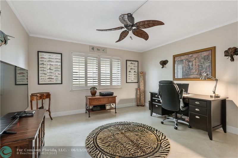 3050 Northeast 47th Court, Unit 301 Fort Lauderdale, FL 33308 - Photo 14 of 19 a workspace with chandelier