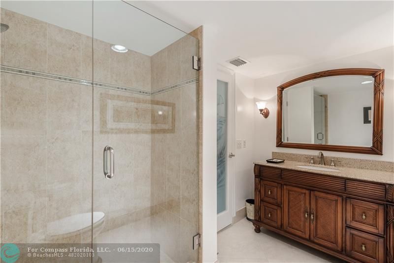 3050 Northeast 47th Court, Unit 301 Fort Lauderdale, FL 33308 - Photo 15 of 19 a bathroom with a double vanity sink mirror and double