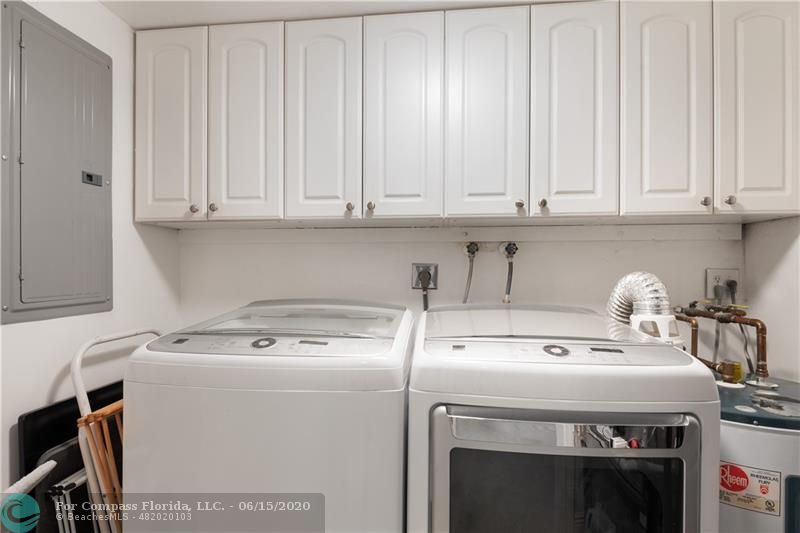 3050 Northeast 47th Court, Unit 301 Fort Lauderdale, FL 33308 - Photo 16 of 19 a utility room with dryer washer and a fridge